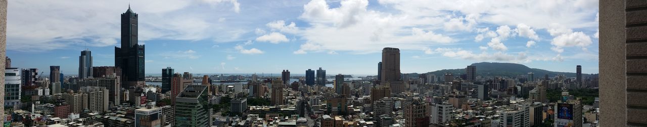 SKYSCRAPERS AGAINST CLOUDY SKY