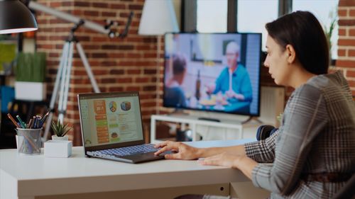 Businesswoman using laptop at office