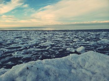 Scenic view of frozen sea against sky during sunset