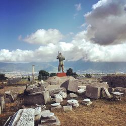 Statue by historic building against sky near naples, italy 