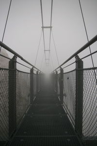 Footbridge against clear sky