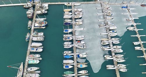 Aerial view of sailboats moored at harbor