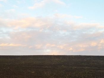 Scenic view of field against sky during sunset