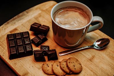 Coffee cup and cookies on table