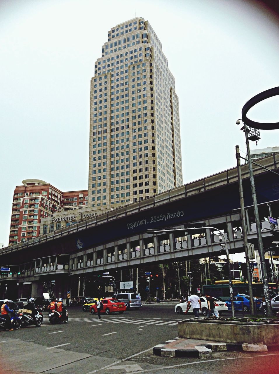 architecture, transportation, built structure, building exterior, land vehicle, city, mode of transport, car, street, road, city life, low angle view, clear sky, city street, sky, office building, modern, travel, bicycle, day