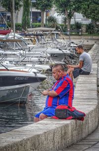 Men sitting on boat in water