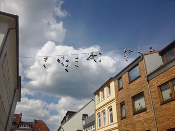 Low angle view of building against cloudy sky