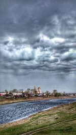 Buildings in city against cloudy sky