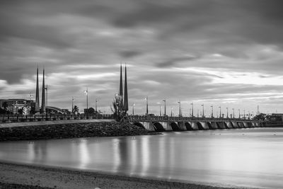 Scenic view of harbor against dramatic sky