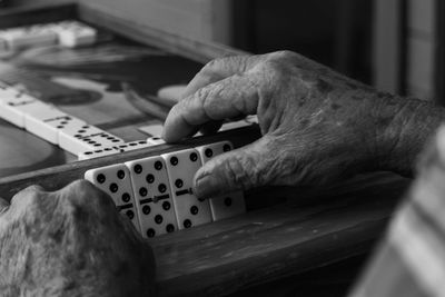 Cropped hands playing domino