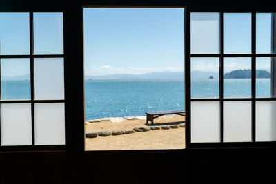 Scenic view of sea against sky seen through window