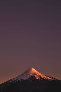 Scenic view of snowcapped mountain against sky during sunset