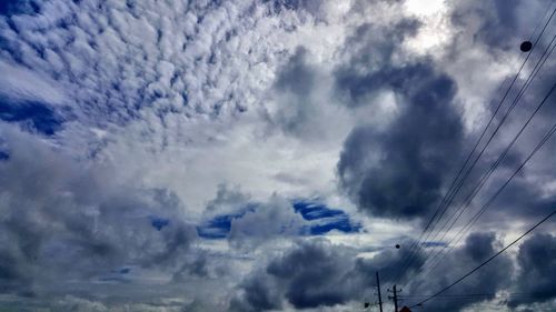 Low angle view of electricity pylon against sky