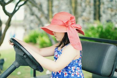 Close-up of child driving a golf cart