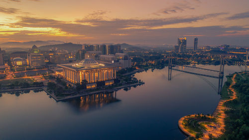 Illuminated city at sunset