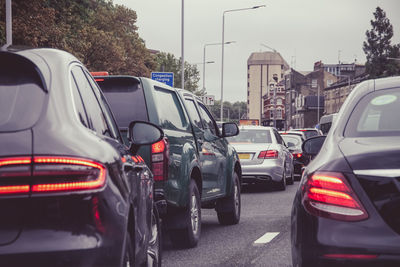 Vehicles on road against buildings in city