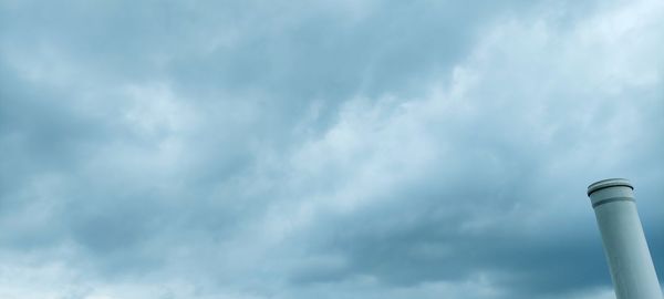 Low angle view of smoke stack against sky