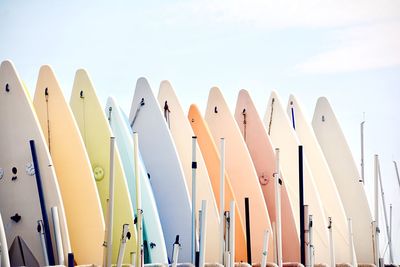 Low angle view of colorful surf boards against sky