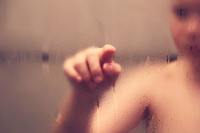 Close-up of human hand on glass