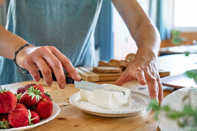 Woman making summer strawberry sandwich. healthy eating, fruit dieting brunch.