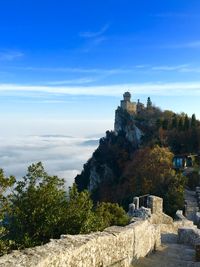 Buildings on mountain by cloudscape at serravalle