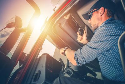 Man driving bus on sunny day