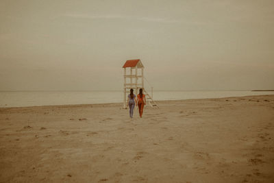 People on beach against sky