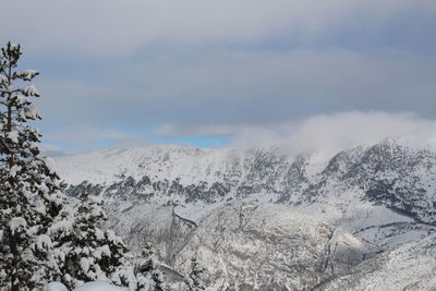 Scenic view of snow covered mountains against sky