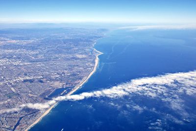 Aerial view of sea and coastline against sky