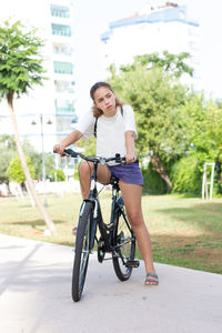 Portrait of smiling young woman on bicycle