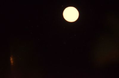 Low angle view of moon against dark sky