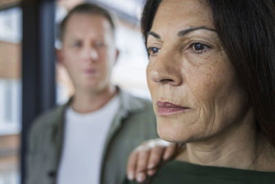 Man touching mature woman's arm