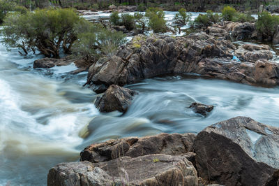 Stream flowing through rocks in sea