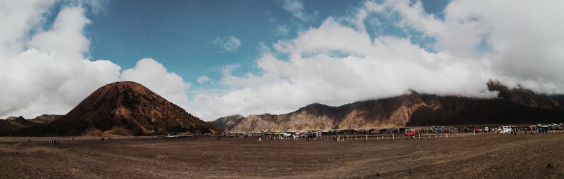 Panoramic view of crowd on mountain against sky