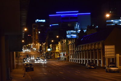 Illuminated city street at night