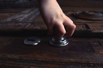 Cropped hand holding door knob