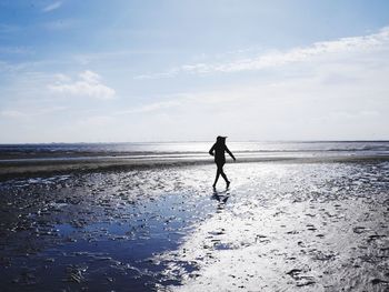 Full length of man on beach against sky