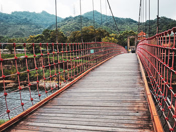 Empty footbridge leading to mountains