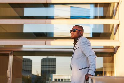 African-american man in a fancy suit enjoying the sunset outside the office.