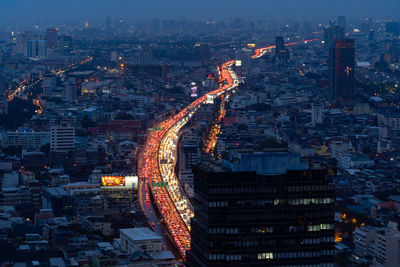 High angle view of illuminated buildings in city at night