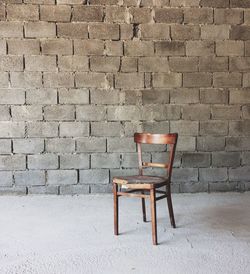 Chair on brick wall