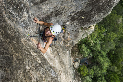 Woman climbing on rock