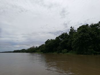 Scenic view of river and trees against sky