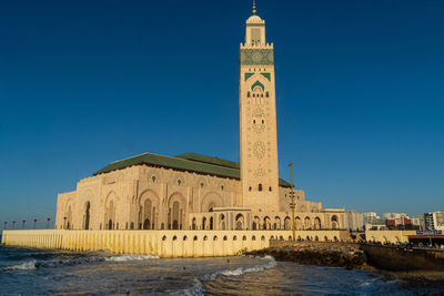 View of hassan ii mosque against blue sky in casablanca, morocco.