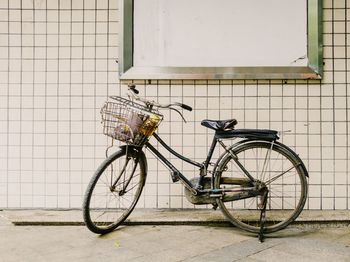 Bicycle against tiled wall