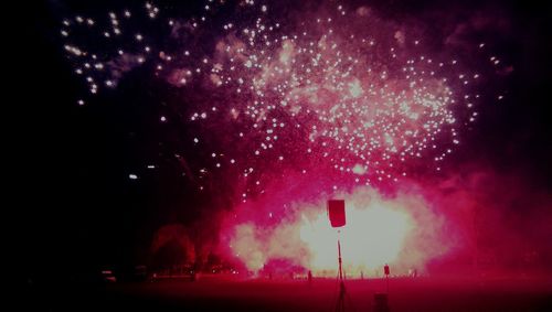 Low angle view of firework display at night