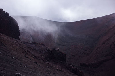 Scenic view of volcanic mountain against sky