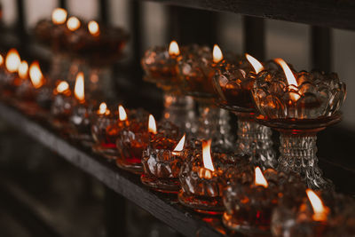 Close-up of burning candles in temple