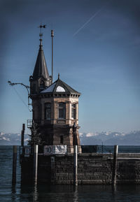 Low angle view of building by sea against sky