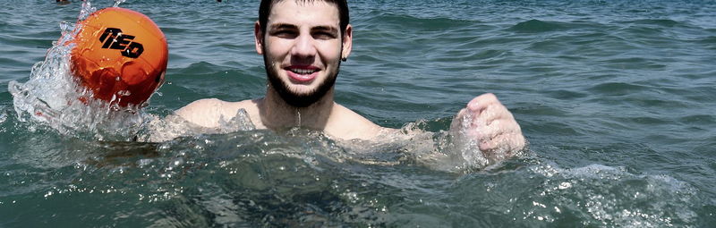 Portrait of boy swimming in sea